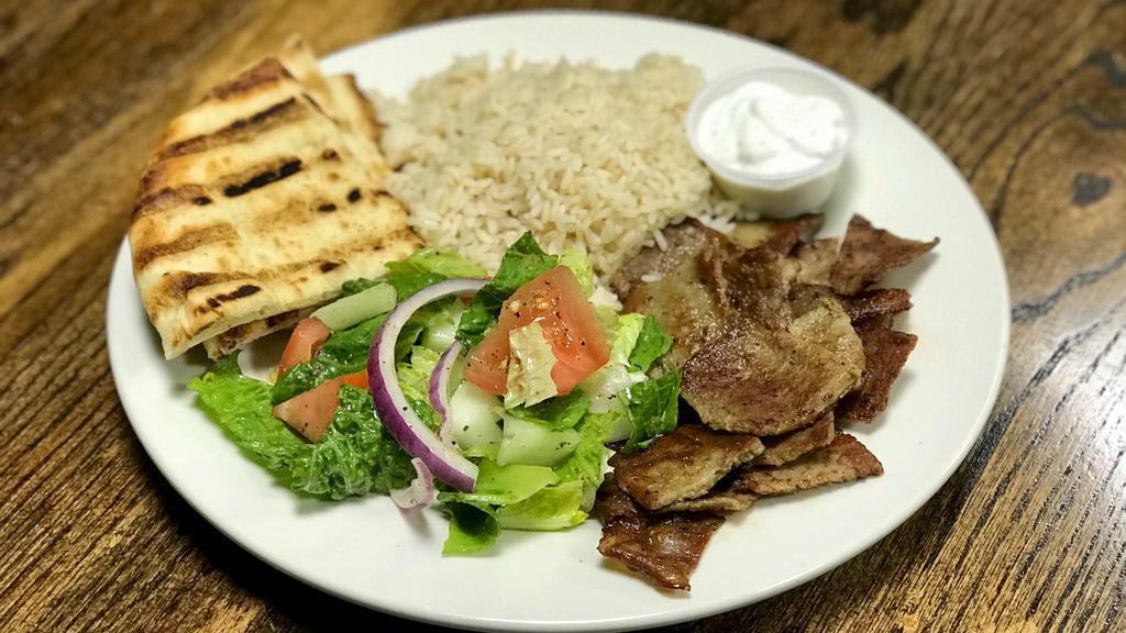 Gyro Platter · Gyro served in a platter with choice of white rice or rice & beans, salad with toasted pita bread.