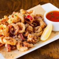 Crispy Calamari · Fresh calamari, zucchini chips, and marinara sauce.