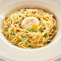 Spaghetti Carbonara · Poached egg, parmigiano cheese, fresh peas, and lardon.