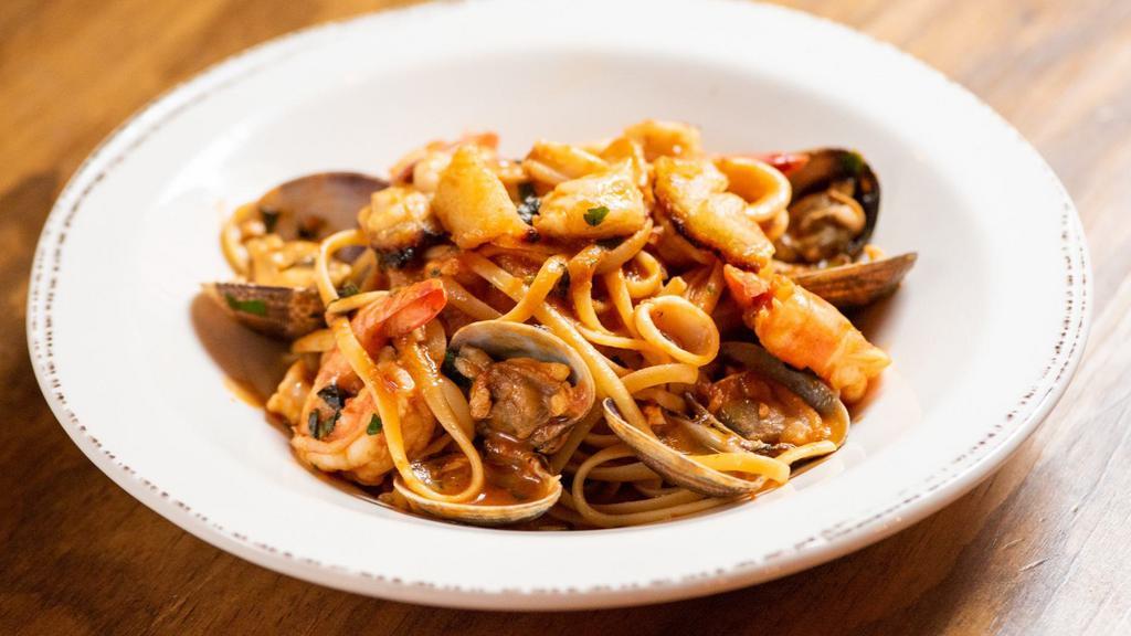 Seafood Pasta · Chucks of fish filets, shrimp, calamari, clams, garlic, red peppers, and cherry tomatoes over linguine in light marinara sauce.