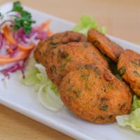 Fried Fish Cake · Thai fish cake served with sweet chili sauce and ground peanut.