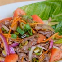 Tiger Tear Salad · Beef salad with dried chili, mint, onions and spicy lime dressing. Hot and spicy.