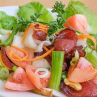 Thai Sausage Salad · Thai sausages with onion, chili, cucumber, red onion and spicy lime dressing. Hot and spicy.
