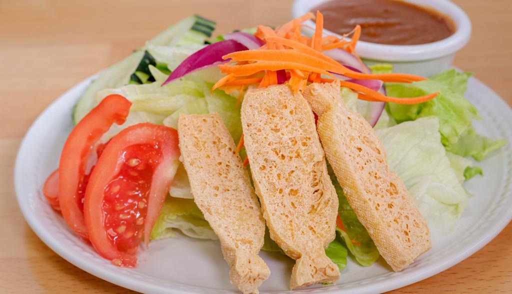 Salad Keak · Mixed green, carrot, cucumber, red onion, tomato, fried tofu served with peanut dressing.