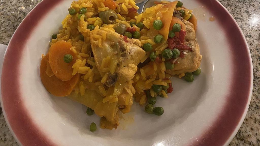 Arroz Con Pollo · Yellow saffron rice with chicken, spanish sausage, and olives.