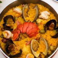 Paella De Mariscos · Yellow saffron rice with mussels, clams, shrimp, squid, and lobster piece(1 pers. ).