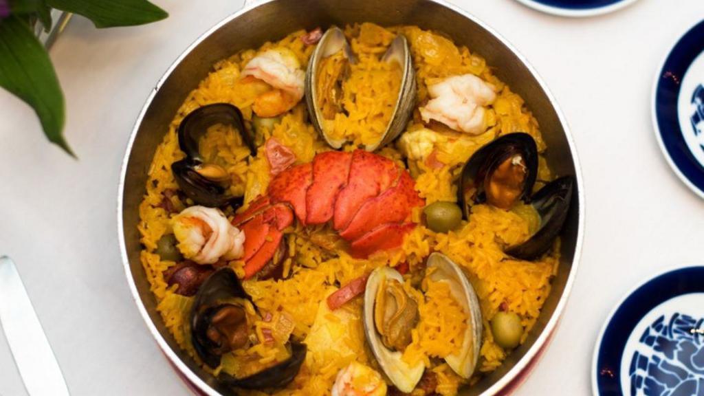 Paella De Mariscos · Yellow saffron rice with mussels, clams, shrimp, squid, and lobster piece(1 pers. ).