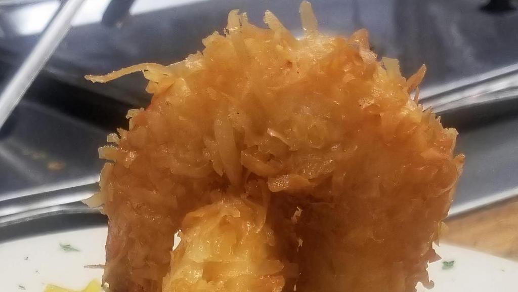 Camarones De Coco · Coconut dipped shrimp over maduro mash.