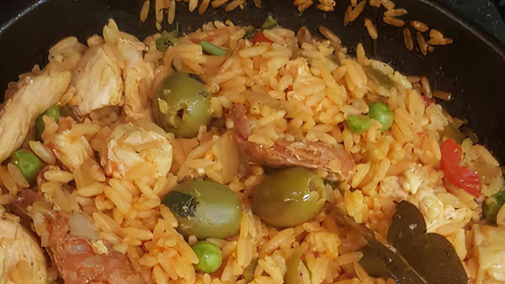 Arroz Con Pollo  · Chicken sautéed in sofrito with chorizo and Spanish olives simmered in a caldera of saffron rice.