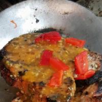 Chuletas De Cerdo · Two centers cut grilled pork chops marinated with a garlic oregano mojo.