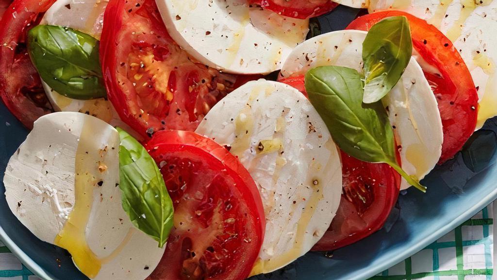 Caprese Salad · Buffalo mozzarella, sliced tomatoes, oregano, baby arugula, balsamic glazed, extra virgin olive oil and fresh basil.