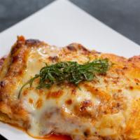 Lasagna Al Forno · Oven baked homemade pasta layered with bolognese ragu and parmesan bechamel.