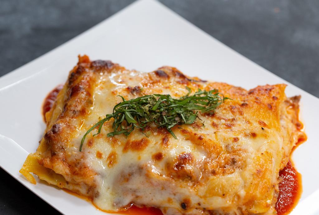 Lasagna Al Forno · Oven baked homemade pasta layered with bolognese ragu and parmesan bechamel.