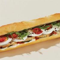 Romesco Chicken & Mozzarella Baguette · Grilled chicken (ABF) topped with mozzarella, roasted tomatoes, basil and arugula, in a hear...