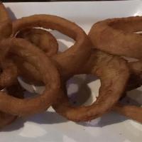 Beer-Battered Onion Rings · A generous portion of golden-fried onions served with horseradish dressing dipping sauce