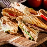 Italiano Panini · Delicious sandwich topped with grilled chicken, mozzarella cheese, roasted peppers, and a pe...