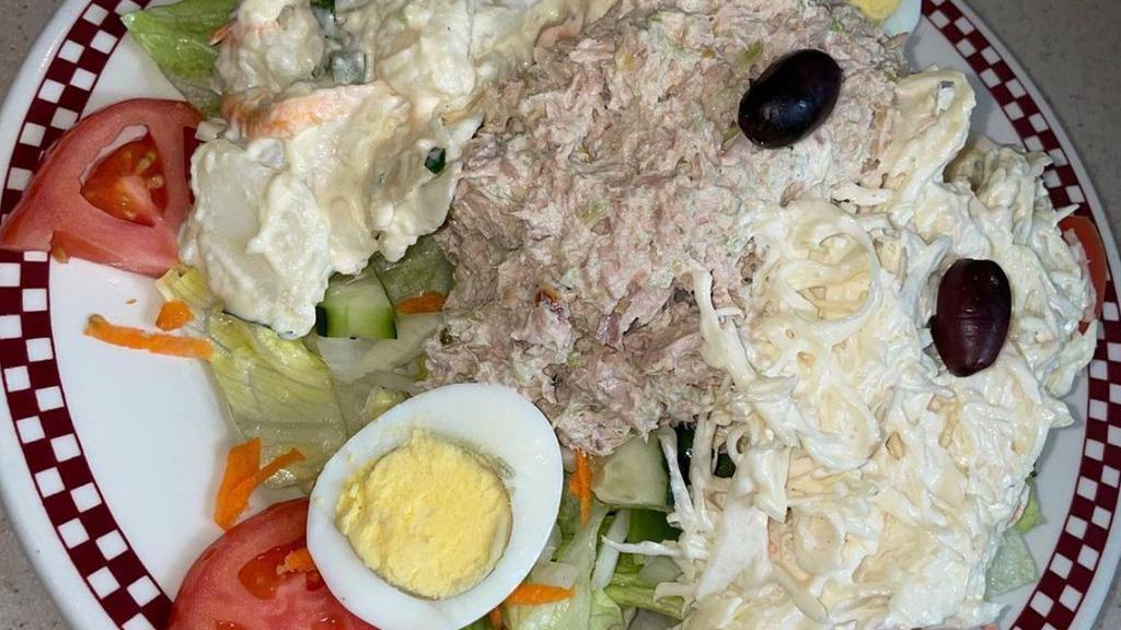 Nicoise Salad · individual tuna on a bed of organic salad with tomato, cucumber, mushrooms, hard boiled eggs, black olives and anchovies.