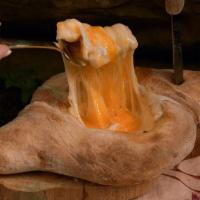 Ajaruli Khachapuri · Oven baked dough filled with sulguni cheese. Formed into an open boat shape and topped with ...