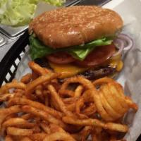 Cheeseburger · 100% Angus beef patty served on a sesame bun, with American, Cheddar or Swiss cheese and a p...