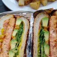Salmon Burger · Salmon burger, tomato, cheddar cheese, avocado, arugula and dijonnaise on a roll.