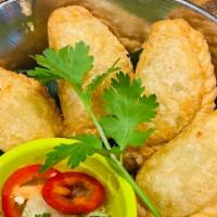 Curry Puffs · Minced chicken, potato, mixed peas & carrot, onion in puff pastry serve with cucumber vinaig...