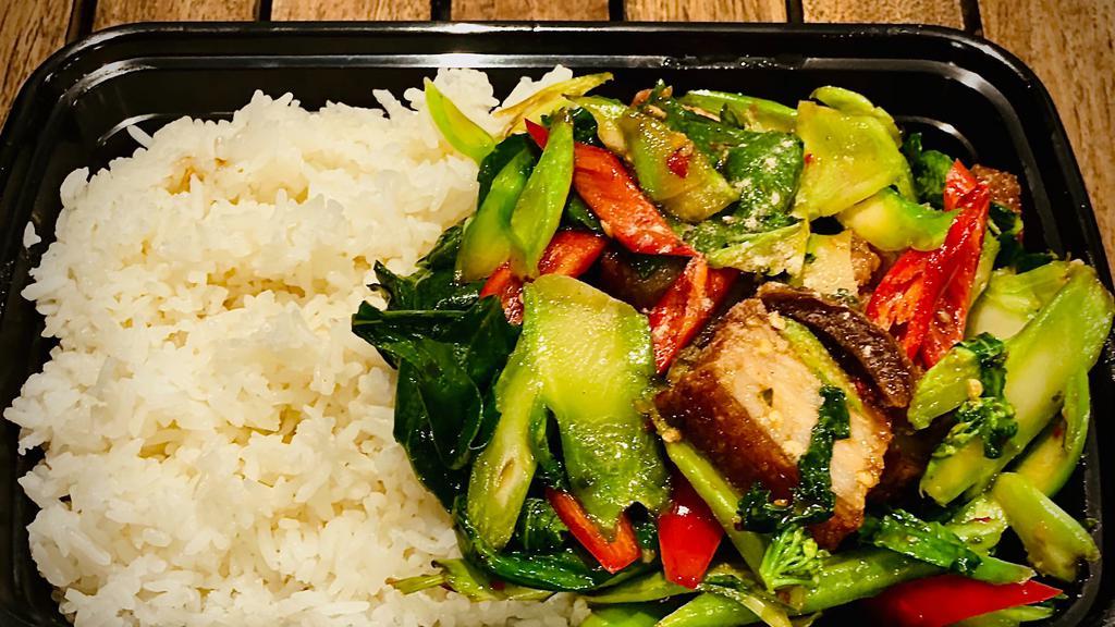 Kana Moo Kob On Rice · Medium spicy. Sautéed Chinese broccoli with crispy pork belly, long hot pepper, chili & garlic in brown sauce.