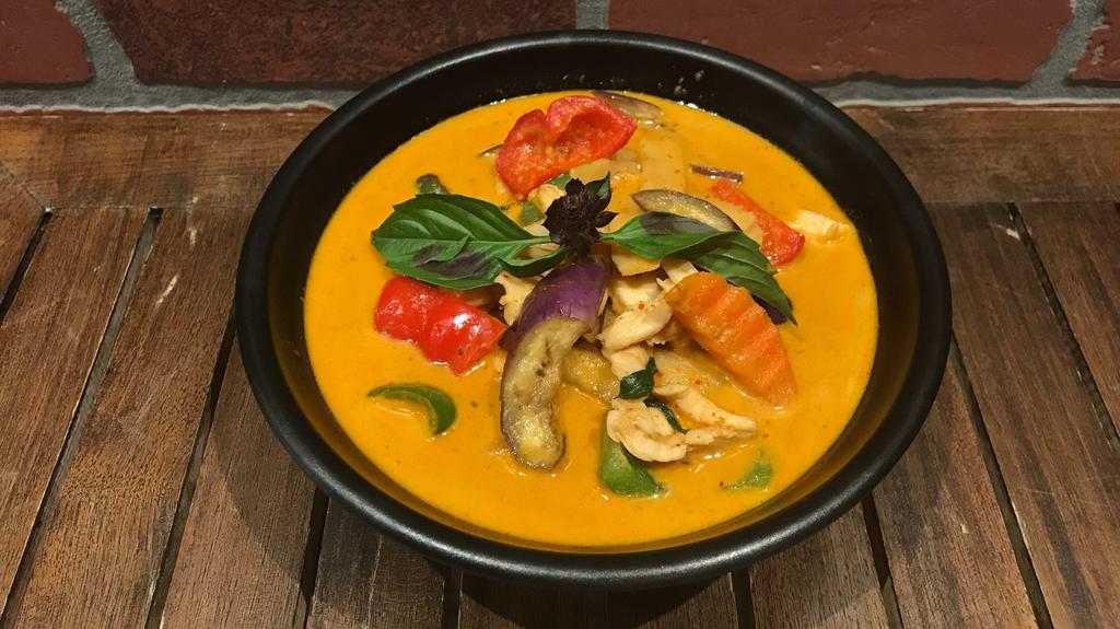 Red Curry · Spicy. Red curry paste, bamboo shoot, eggplant, carrot, bell pepper & basil in coconut milk, served with jasmine rice.