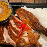 Chu Chee Duck · Crispy quarter Long Island duck with Chu Chee sauce on a bed of steamed string bean and Amer...
