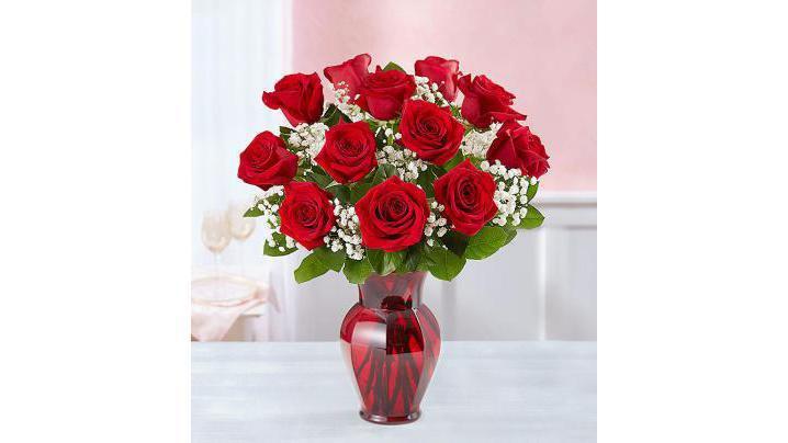 Blooming Love · Sometimes flowers speak louder than words and our elegant red roses speak volumes! Beautifully hand-arranged with lush greenery inside our exclusive ruby red vase, each radiant bloom will help you express your love in the most romantic way possible.