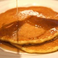 Pancakes · 3 light and fluffy buttermilk pancakes with a dash of powdered sugar.
