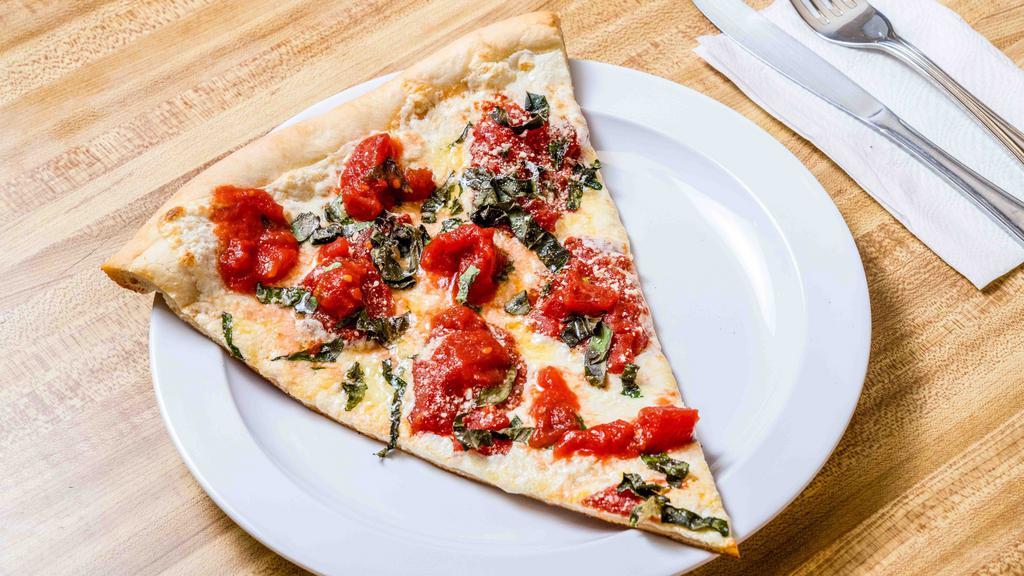 Margherita Pizza · Fresh plum tomatoes, fresh mozzarella, and basil on a thin crust topped with olive oil and grated cheese.