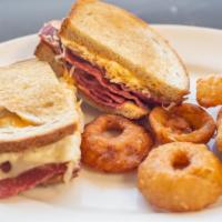 Turkey Or Corned Beef Reuben · Sauerkraut, Russian dressing and Swiss cheese on a grilled rye bread.