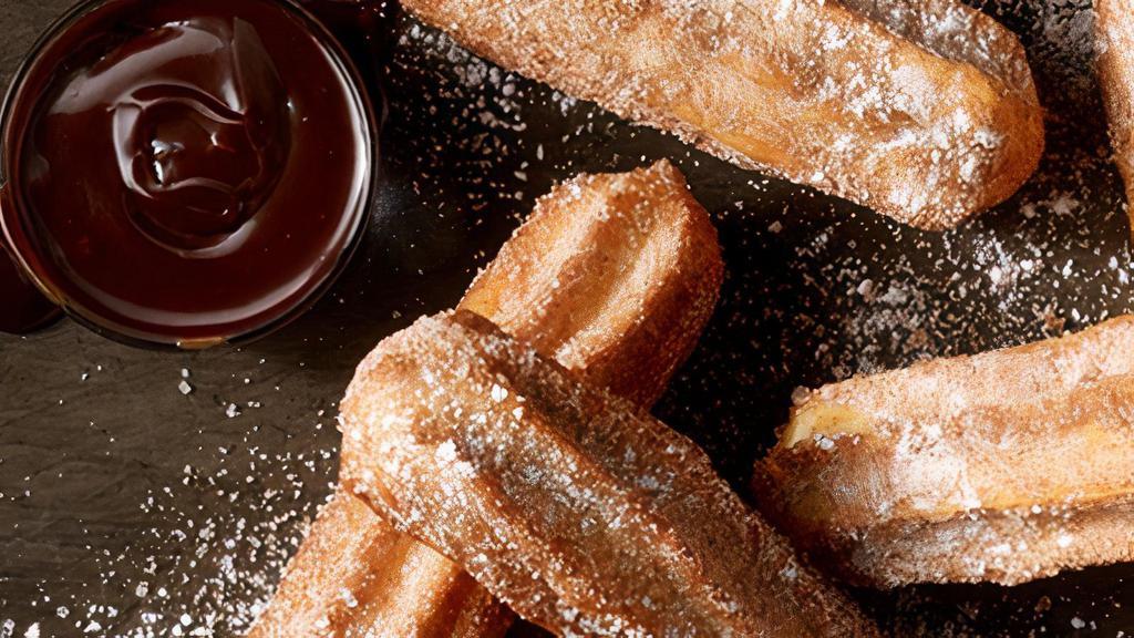 Cinnamon Sugar Churros · Chocolate- and caramel-filled churros with chocolate dipping sauce.