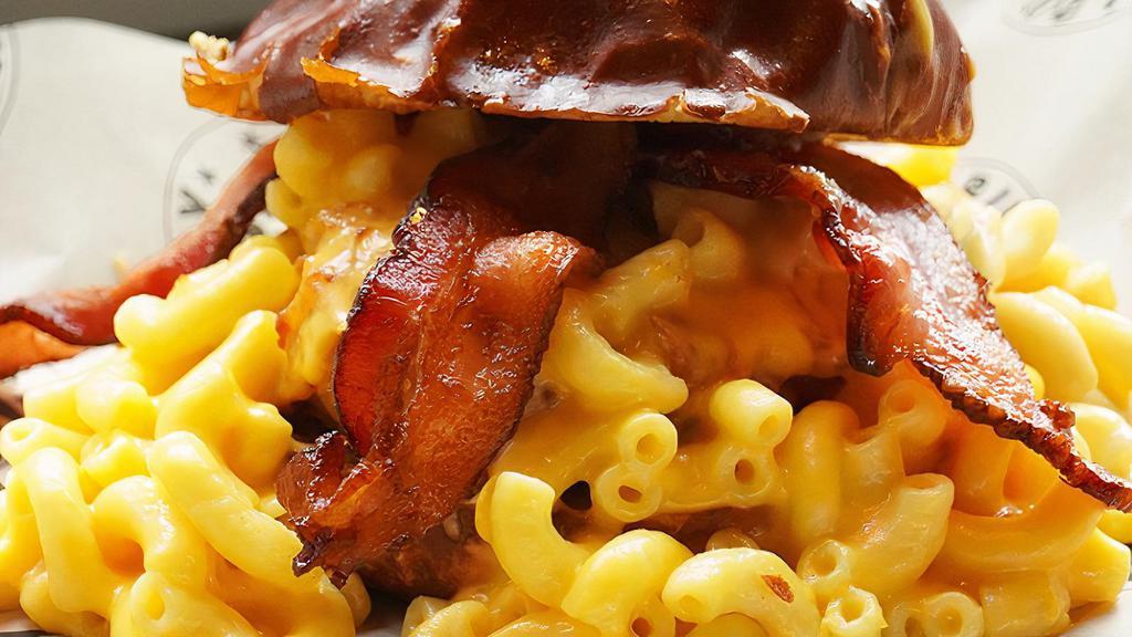 Mac Attack · 1/2 POUND Signature blend with bacon, smothered with mac and cheese and cheese sauce, served on a pretzel bun.