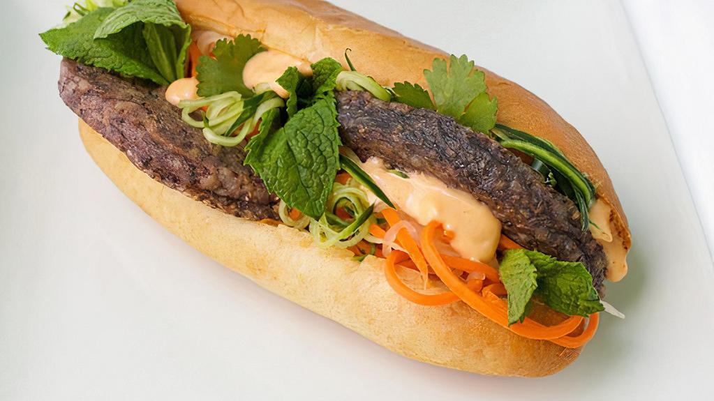 Taro Bahn Mi  *Veg* · Taro patty, daikon pickle, cucumber, cilantro, mint , sriracha veganaise, black bean chili oil,