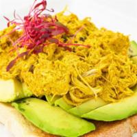 Avo Toast - Curried Chicken · Curried chicken, avocado, and microgreens.