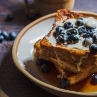 Blueberry French Toast A La Carte · Bread soaked in eggs and milk, then fried and topped with blueberries served with a side of ...