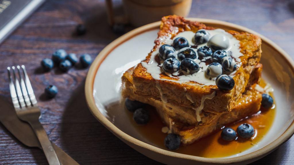 Blueberry French Toast A La Carte · Bread soaked in eggs and milk, then fried and topped with blueberries served with a side of syrup and butter.