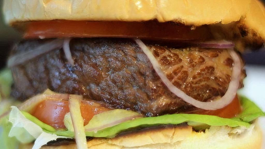 Chipotle Short Rib Burger · Braised Short Rib, Chipotle Aioli, Lettuce, Cucumber and Tomato on a toasted Brioche.