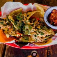 Nachos · Chips and nacho cheese with jalapeños and refried beans and stuff