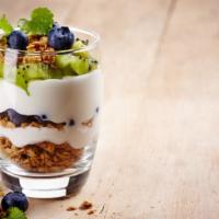 Yogurt Parfait · Sweet dessert made of layered ingredients in a tall glass.
