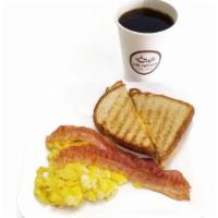 American Breakfast · 2 Scrambled eggs, 2 Bacon strips, Sandwich With yellow cheese and  Black coffee 12 oz
