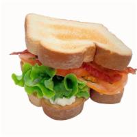 Blt Sandwich · Toasted Bread, Bacon, fresh green leaf lettuce  and tomatoes with mayo on it