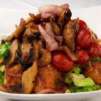 Halloumi Style Salad · Fresh green salad topped with sautéed fried mozzarella cheese, mushrooms, onions, cherry tom...