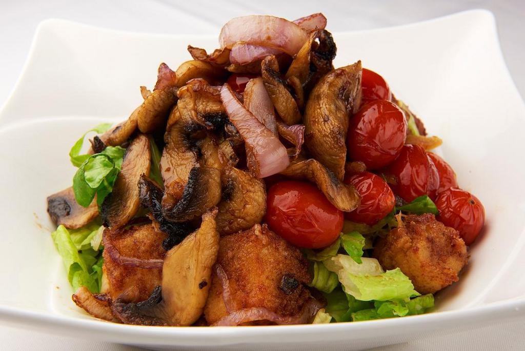 Halloumi Style Salad · Fresh green salad topped with sautéed fried mozzarella cheese, mushrooms, onions, cherry tomatoes served with teriyaki sauce
