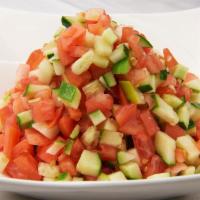 Israeli Salad · Classical Israeli salad, cucumbers, tomatoes, fresh ground pepper served with lemon and oliv...