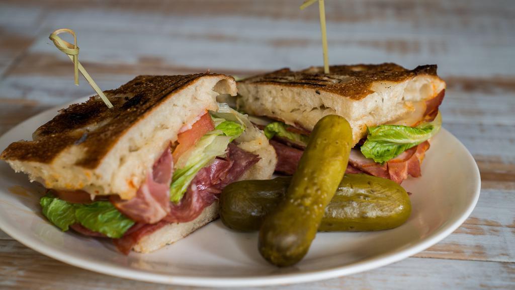 The Stallion · Classic Italian meats, hard salami, and capicola grilled and topped with melted provolone cheese, lettuce, tomato, banana peppers, and an Italian oil dressing, on our herbed scratch baked focaccia bread.