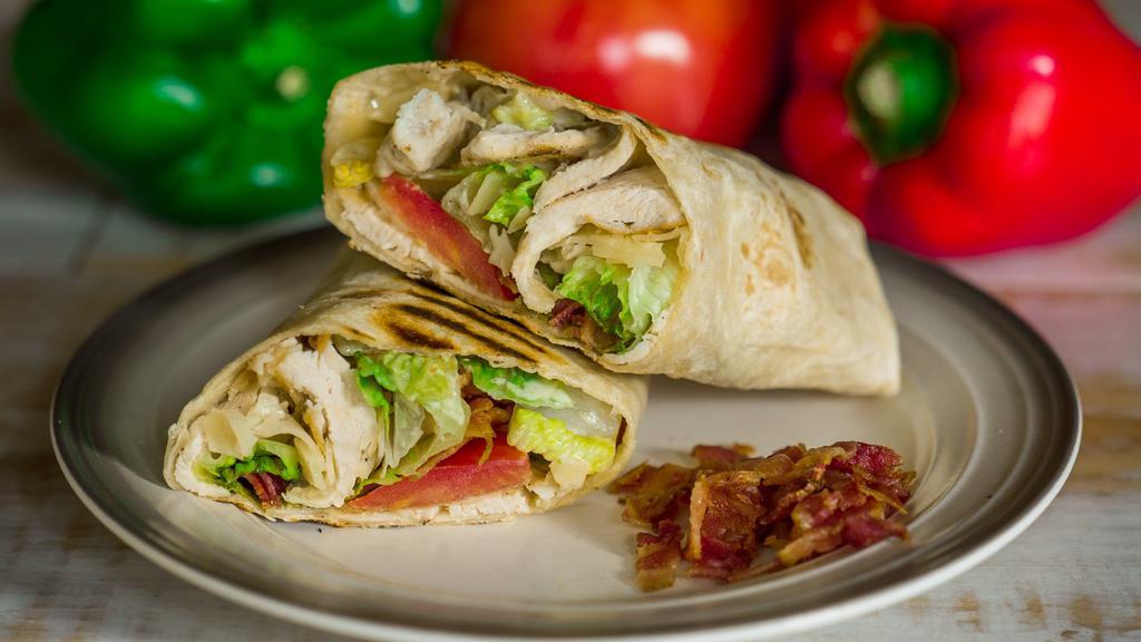Chicken Caesar Wrap · Grilled chicken, crisp romaine, bacon, tomato, and a blend of Parmesan cheeses tossed in a creamy caesar dressing in a multi-grain wrap.