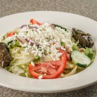 Greek Salad · Fresh lettuce, tomatoes, cucumber, onion, peppers, olives, feta cheese, and stuffed grape le...