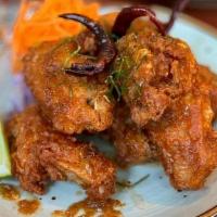 Tom Yum Wings · Crispy chicken wings coated with sweet and sour Tom Yum sauce